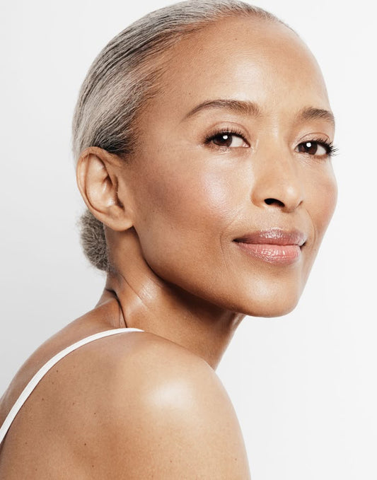 Elegant older Asian woman with healthy, radiant skin showcasing graceful aging through Korean skincare